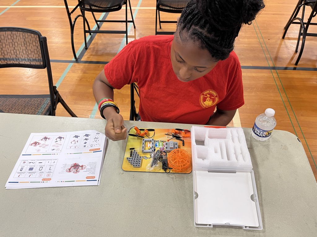 Young female student working with a STEM kit