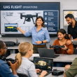Group of people learning about UAS pre-flight checks in a classroom setting.